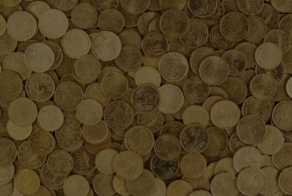 Header image for the blog "The Scalable Side Hustle: Build Once, Sell Thousands" by Layan Faraj, with a background of stacked coins.