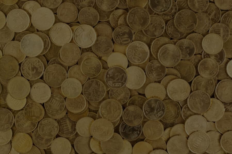 Header image for the blog "The Scalable Side Hustle: Build Once, Sell Thousands" by Layan Faraj, with a background of stacked coins.